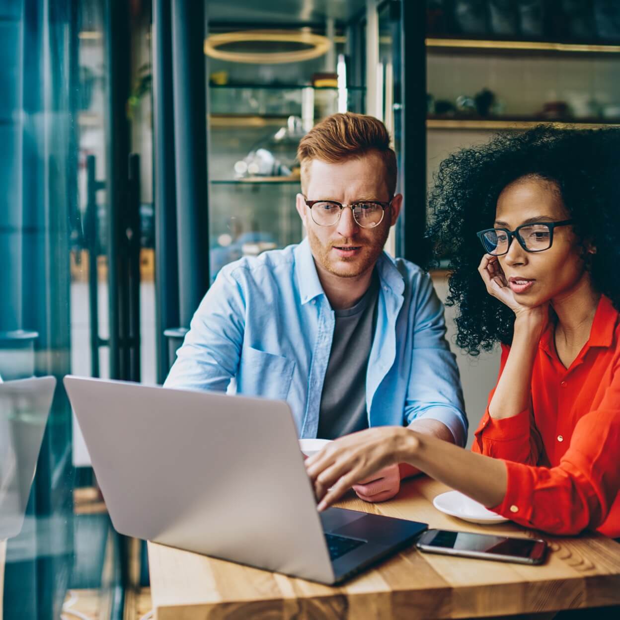 Man and woman in discussion with laptop